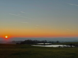 sunset on golf course with lakes