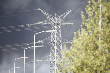 Thick smoke rises from industrial fire under darkening storm clouds