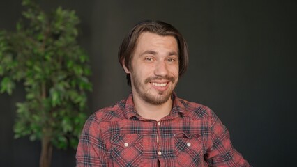 Man college student studying at home pov, listening watching lesson online on computer, looking at camera smiling expression. Modern online education.