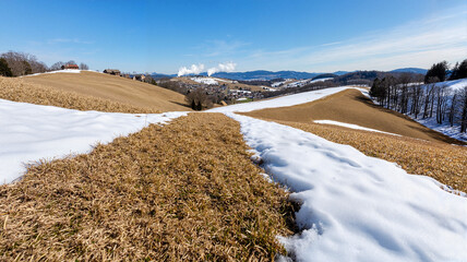Snow-covered grass field in winter landscape