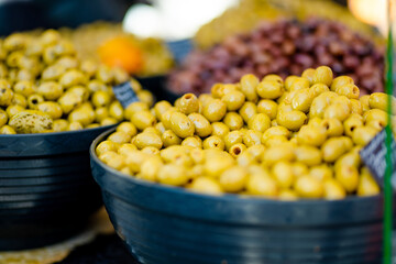Assorted organic pickled olives, garlic, hot peppers, capers and sundried tomatos sold on a marketplace in Vilnius, Lithuania, during Kaziukas, traditional spring fair.