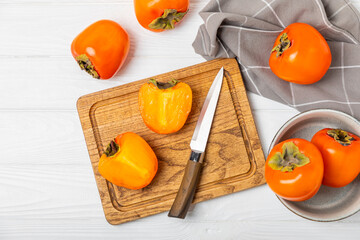 Persimmon on textured wooden background. Persimmon fruit. A piece of ripe, juicy, sweet persimmon fruit. Vegan. Orchard. Close-up. Space for text. Copy space.