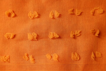 Pumpkin orange color dobby cotton fabric texture seamless with beautiful closeup detail fabric. Luxury dobby cotton textile pattern with soft and delicate material.