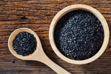 Black sesame in bowl on wooden background