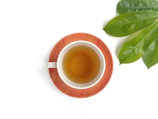 Soursop leaf boiled water in glass on white background with top view angle setup, healthy drink lifestyle 