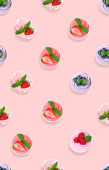 Pattern of cupcakes with berries on pink background, top view