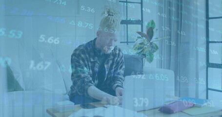 Image of financial data processing over albino african american businessman using laptop