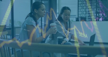 Image of financial data processing over diverse female colleagues discussing work in office