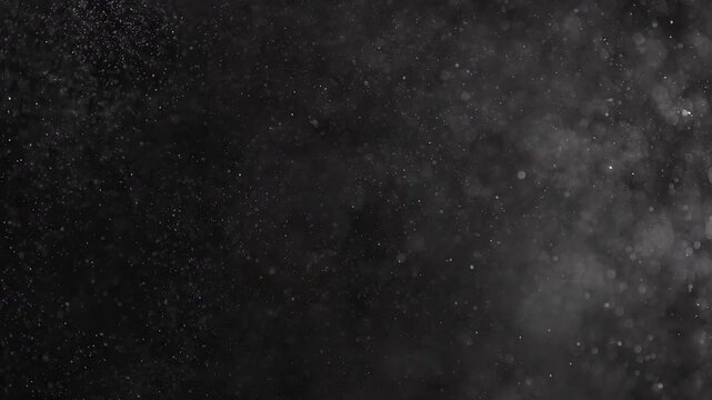 Realistic video of a strong air pressure similar to an explosion filling the video with particles similar to dust, water drops, snowstorm.