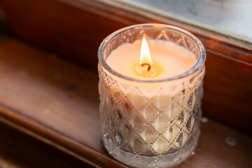 Cozy Lit Candle on Wooden Surface