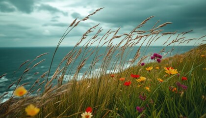 Coastal wildflowers sway in the wind, overlooking a dramatic ocean scene under a stormy sky. A breathtaking view of nature's resilience.