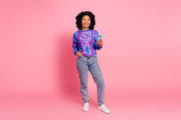 Photo of lovely cute woman wear trendy clothes holding iphone isolated on pink color background