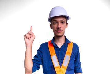 Young architect wearing white helmet and luminous vest posing for photo and making hand gesture. Isolated on white background.