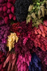 A vibrant array of assorted flowers in rich colors, showcasing shades of purple, pink, yellow, and green, creating a visually stunning floral display.