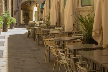Cafe tables on the street of Italy in the city of Vicenza on a bright sunny day