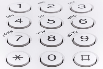 Round plastic buttons with numbers on office equipment