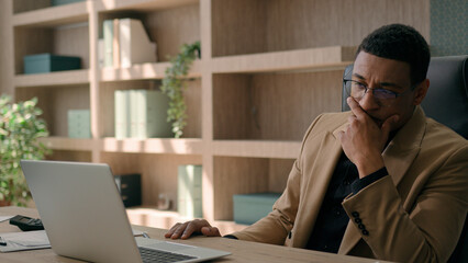 Upset stressed African American man negative emotion fail business project with laptop desperate...
