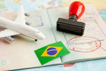 Brazil flag and passport with airplane for travel.