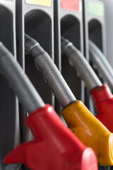 Colorful fuel pump nozzles at a modern gas station.