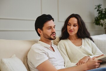 Couple enjoying a cozy conversation on a sofa in a bright living room