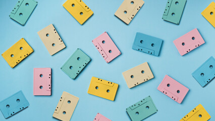 Colorful vintage cassettes on blue background. Top view. 