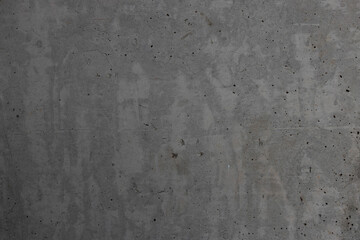 A detailed texture of raw gray concrete with cracks and small imperfections. Concept of industrial design. Suitable for backgrounds, architectural visuals, and graphic design projects.