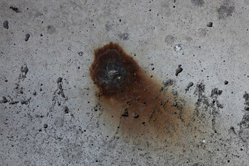 A textured surface of gray concrete with rust stains and imperfections, showcasing an industrial and weathered aesthetic. Concept of urban decay. Ideal for backgrounds, architectural designs, and grap