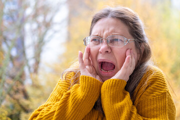 Woman covering ears with pained expression, Emotional portrait showing discomfort loud noise,...