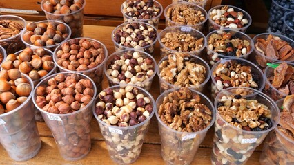 Fresh Nuts in Transparent Cups, Farme produce of organic healthy diet food. Market Grocery Shopping Display Close-Up