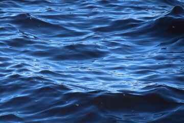 Close up of rolling waves on blue surface of river water