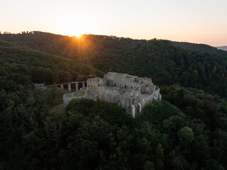 Fototapeta premium Neamt Fortress (Cetatea Neamtului in Romanian language). Aerial photo with a beautiful sunrise over this iconic fortress from Moldova, Romania. Travel to Romania history landmarks.