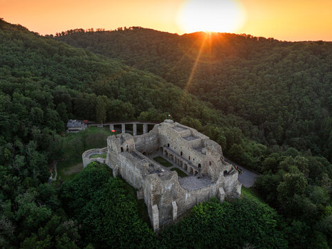 Neamt Fortress (Cetatea Neamtului in Romanian language). Aerial photo with a beautiful sunrise over this iconic fortress from Moldova, Romania. Travel to Romania history landmarks.
