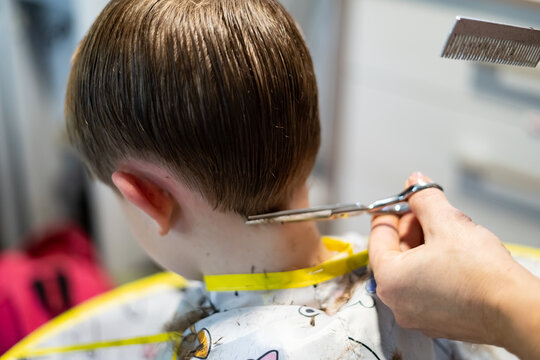 Blond Boy Getting a Haircut with Scissors and Clippers.