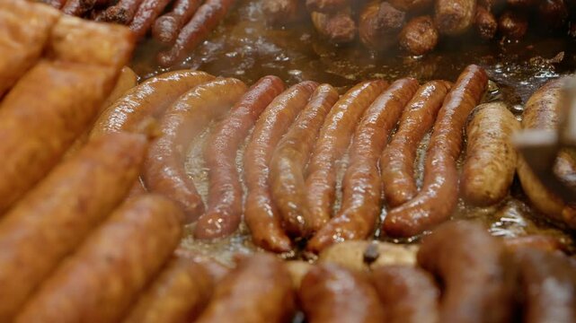 Delicious sausages sizzling on a hot plate, emitting fragrant steam in a bustling street food market
