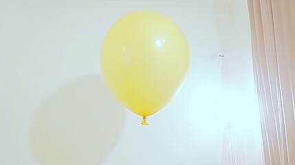 A solitary yellow balloon gently hovering in the center of a pristine white background with a minimalist touch