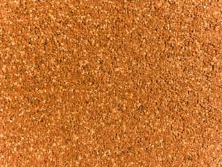 A close up of a brown surface with many small dots