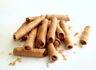 delicate wafer rolls. delicious sweet tubes with caramel on a light background