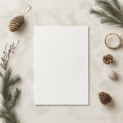 A white piece of paper sits on a table with pine cones and a string