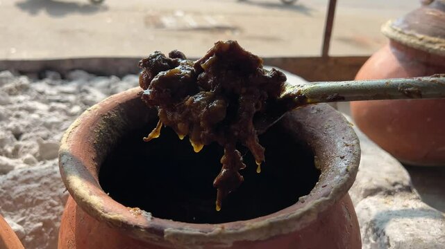 Showing of perfectly cooked mutton pieces from mutton handi.