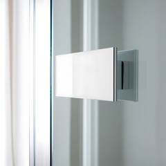 Highly polished and modern, and sleek blank white nameplate mounted on a pristine glass door, slightly angled to capture a subtle yet sophisticated reflection.