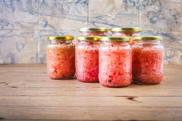 Cabbage sauerkraut with beetroot in jars. Fermented preserved vegetarian food concept.