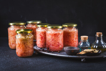 Cabbage sauerkraut with beetroot in jars. Fermented preserved vegetarian food concept.