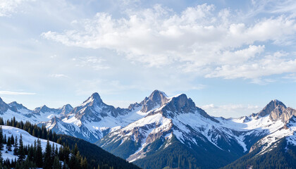 Snow-capped mountains under a blue sky with white clouds  
