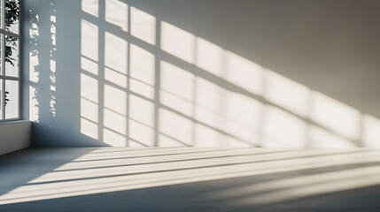 Obraz premium Sunlight casts window shadows on a minimalist white wall and floor. background backdrop banner image with window for online presentations and zoom meetings idea for copy space