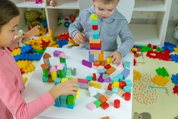 Fototapeta premium Children playing with toys in the room. Selective focus