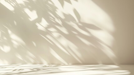Obraz premium Soft shadows of leaves create an intricate pattern on a light wall, evoking a serene and peaceful ambiance.