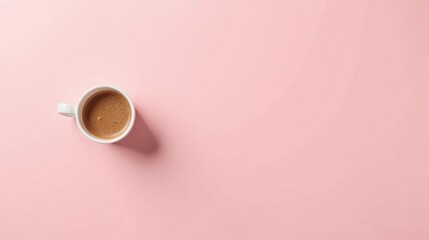 Fototapeta premium A single cup of coffee rests on a soft pink surface, a simple yet elegant image perfect for various design projects needing a touch of minimalist sophistication.