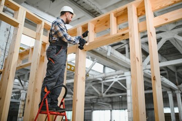 A carpenter works on the construction of modular houses