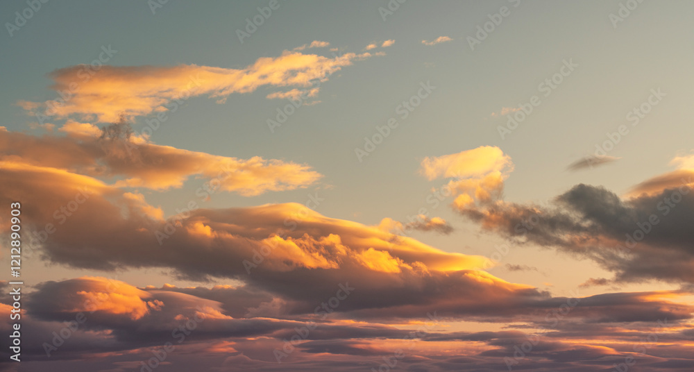 Wall mural beautiful orange sunset clouds on the blue sky. sky background.