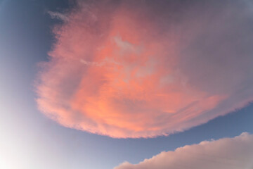 Beautiful orange  sunset clouds on the blue sky. Sky background.